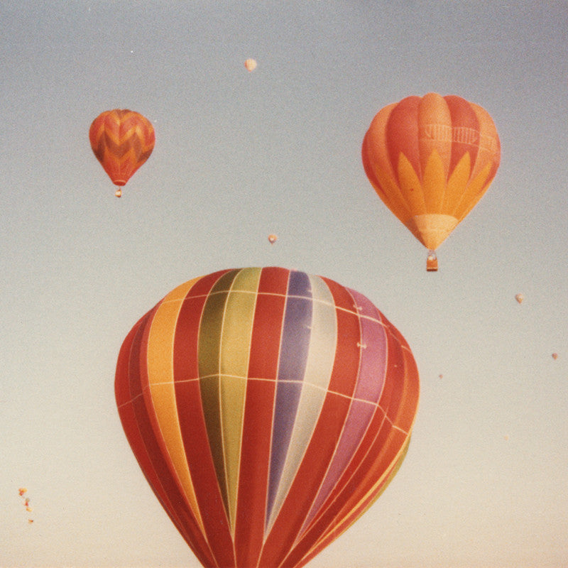 Vintage 70's style color photo air balloons flying in the sky