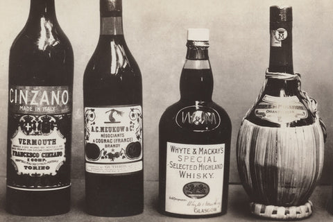 Black and white vintage photograph of various liquor bottles